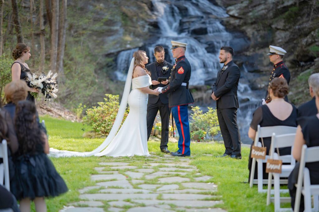 Atlanta Wedding Venue Ceremony outdoor spaces with waterfall backdrop, bride & groom exchange vows, North Geogia wedding reception to follow