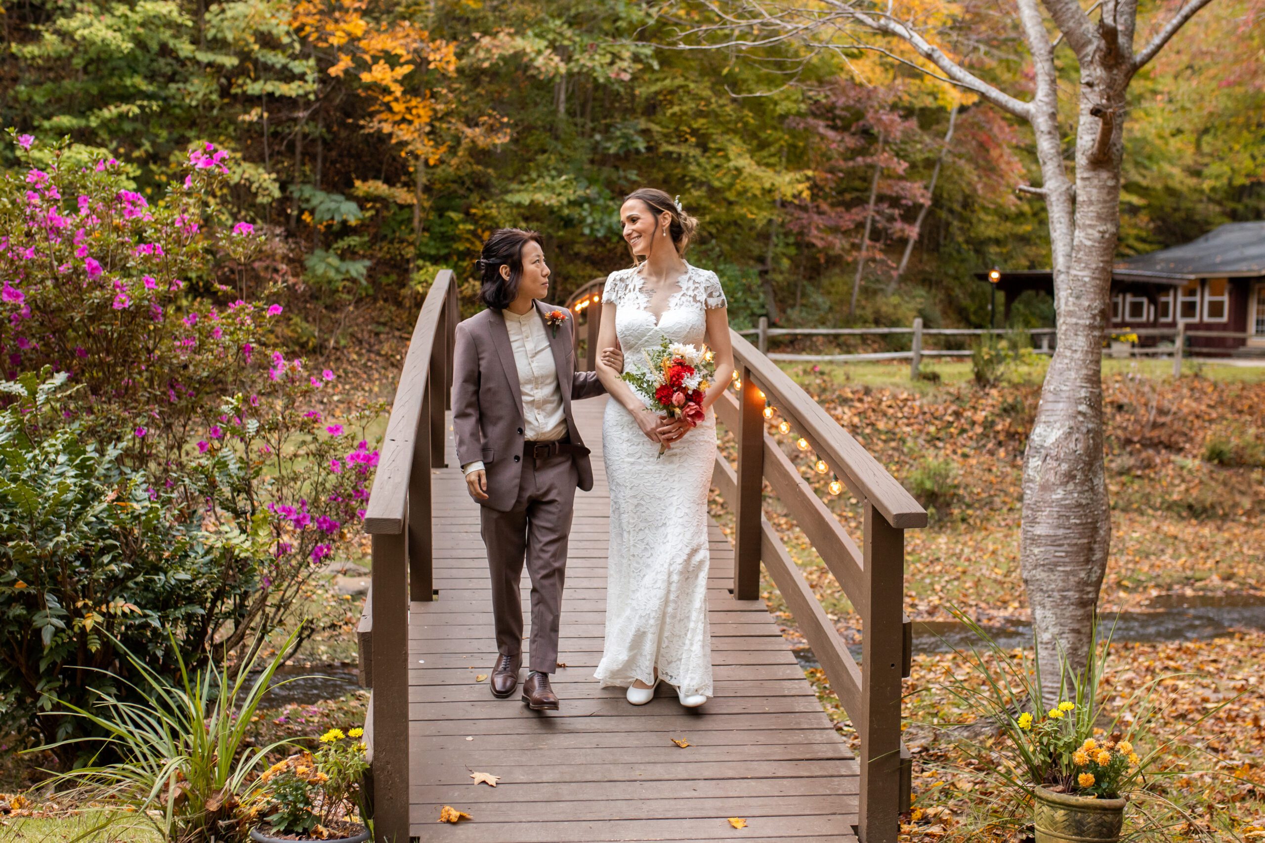 North Georgia wedding venue bride and groom pose for photos at a luxury outdoor wedding ceremony bridge with waterfall