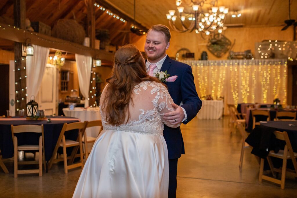 Bride and groom first dance at a wedding venue with waterfall near Atlanta Wedding Venue