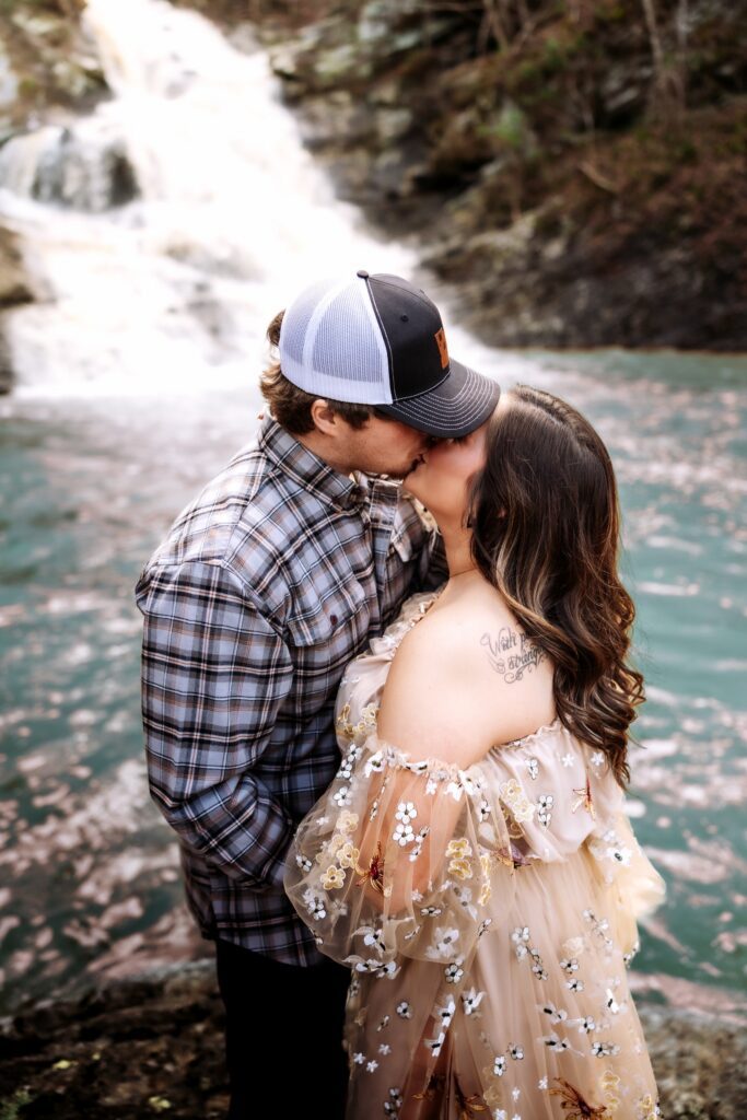 Engaged couples posing for engagement photos at a waterfall wedding venue