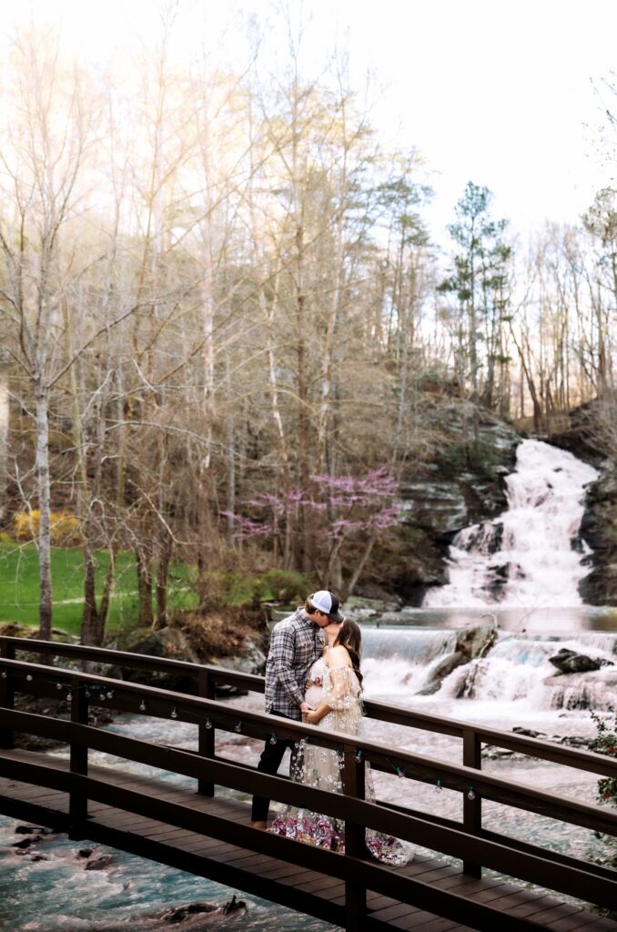 Our beautiful couple poses for maternity photos at our garden wedding venue, waterfall wedding venue near Atlanta.