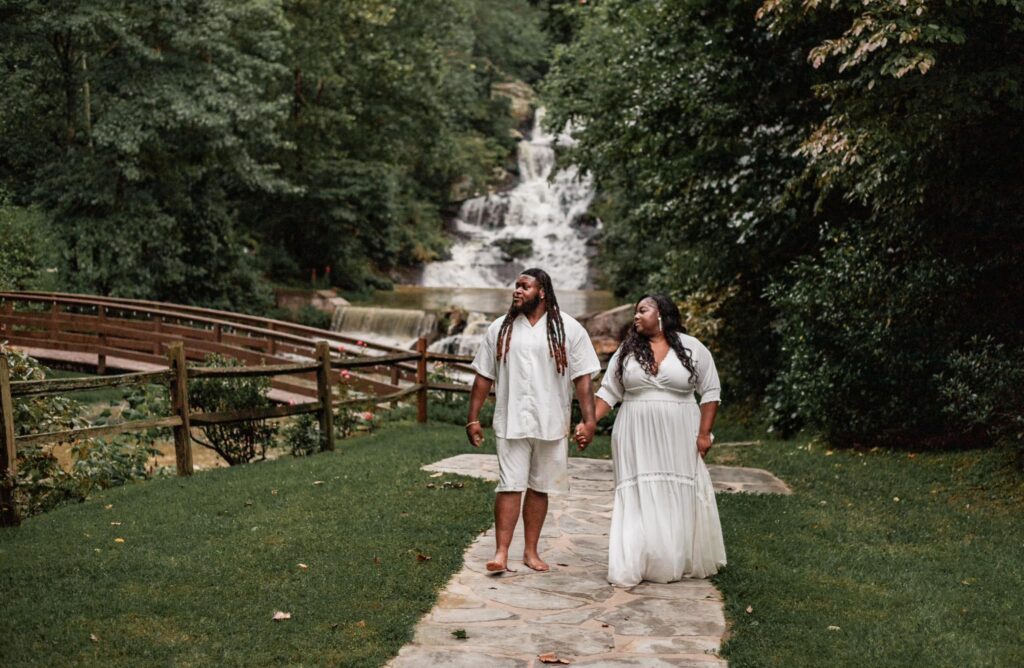 Our beautiful couple poses for engagement photos at our waterfall wedding venue near Atlanta.