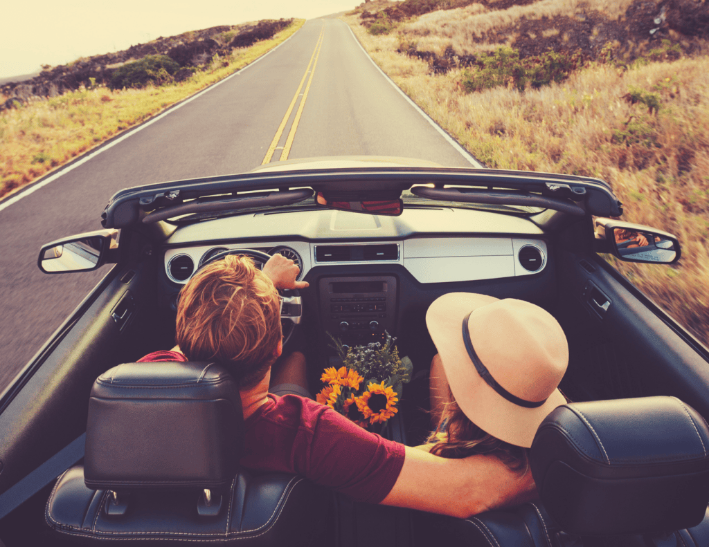 Couple driving to the 25 Top Tourist Attractions in Georgia for Romantic Road Trip