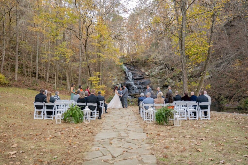 Our bride and groom exchange vows at our outdoor wedding ceremony with waterfall backdrop near Atlanta. 