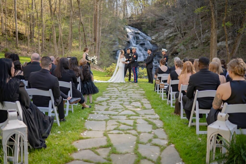 Spring outdoor wedding ceremony with waterfall backdrop