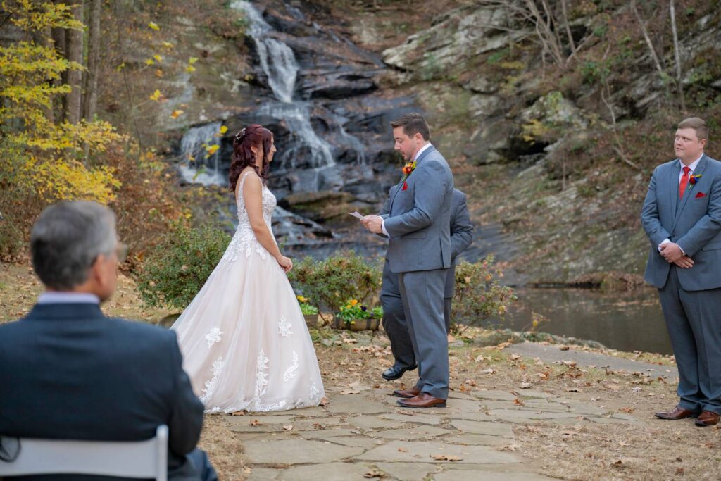 Outdoor ceremony space at Hightower Falls wedding venue near Atlanta with seating for wedding guests beside the waterfall.