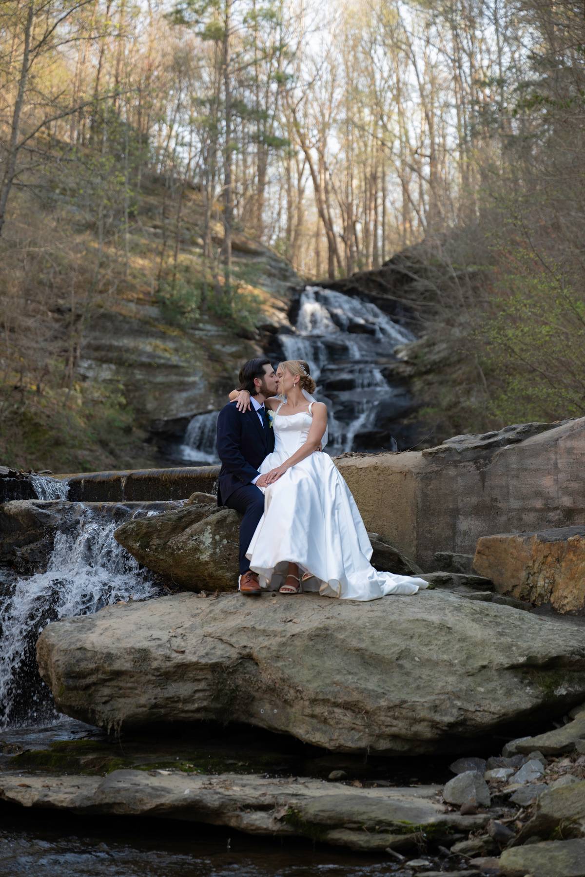 Wedding couple celebrating beside the waterfall at Hightower Falls in Cedartown, Georgia